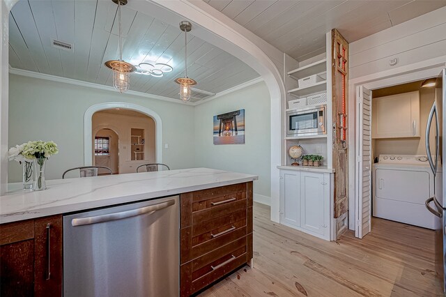 kitchen with ornamental molding, light wood-type flooring, washer / clothes dryer, pendant lighting, and stainless steel dishwasher