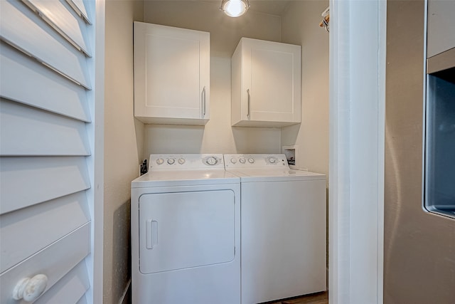 washroom with cabinets and washer and dryer