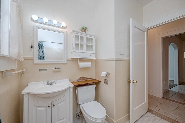 bathroom featuring toilet, vanity, and tile patterned flooring