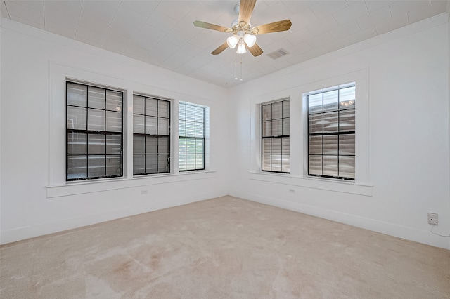 spare room with light colored carpet and ceiling fan