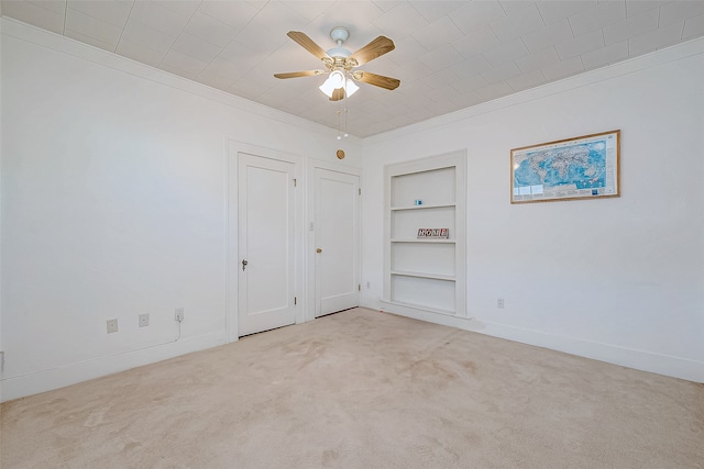 unfurnished bedroom with light carpet, ceiling fan, and crown molding