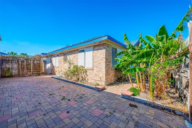 view of side of home featuring a patio area