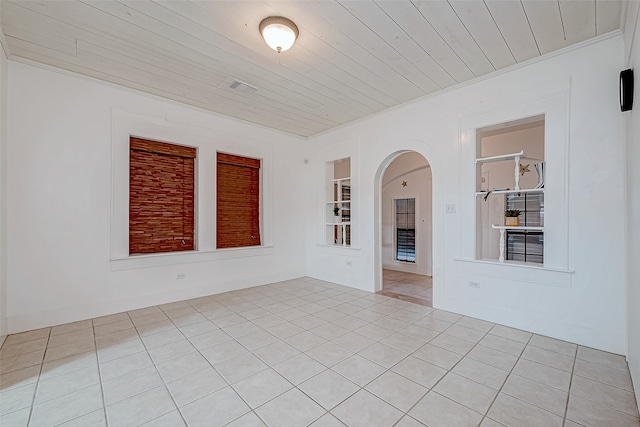 tiled spare room with wooden ceiling