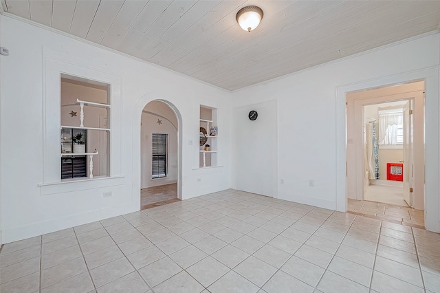 unfurnished room with ornamental molding, built in features, light tile patterned flooring, and wood ceiling