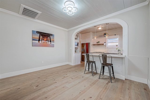 interior space featuring light wood-type flooring, wooden ceiling, and ornamental molding