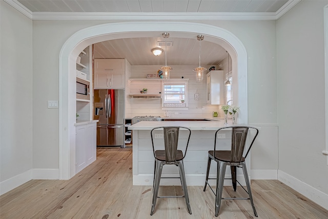 kitchen with light hardwood / wood-style flooring, white cabinetry, crown molding, and stainless steel appliances