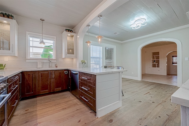 kitchen featuring white cabinetry, light hardwood / wood-style floors, hanging light fixtures, and sink