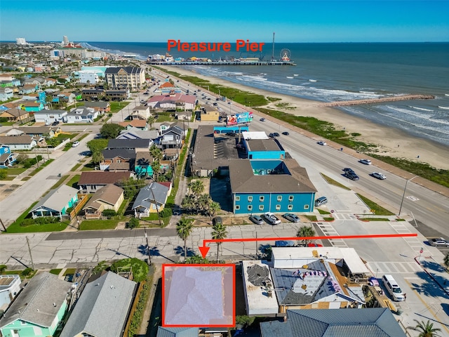 birds eye view of property with a view of the beach and a water view