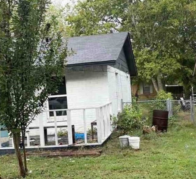 view of property exterior featuring a storage unit and a yard