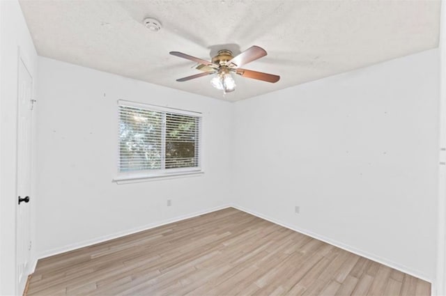 unfurnished room with a textured ceiling, light hardwood / wood-style floors, and ceiling fan