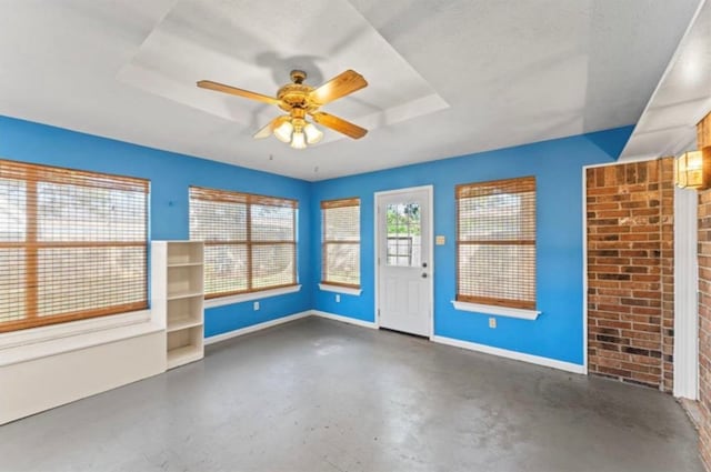 empty room featuring a textured ceiling and ceiling fan