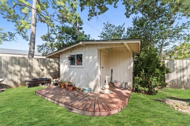 back of property with a lawn and an outdoor structure