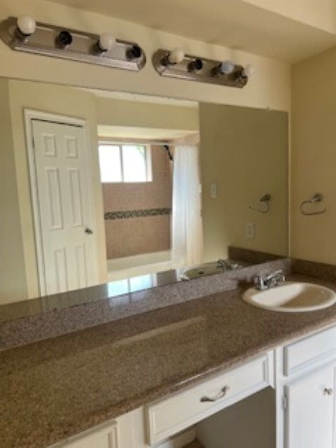 bathroom with vanity and curtained shower