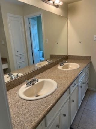 bathroom with vanity and tile patterned floors