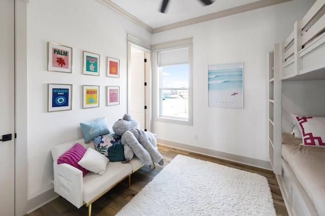 bedroom with dark hardwood / wood-style floors, ceiling fan, and crown molding