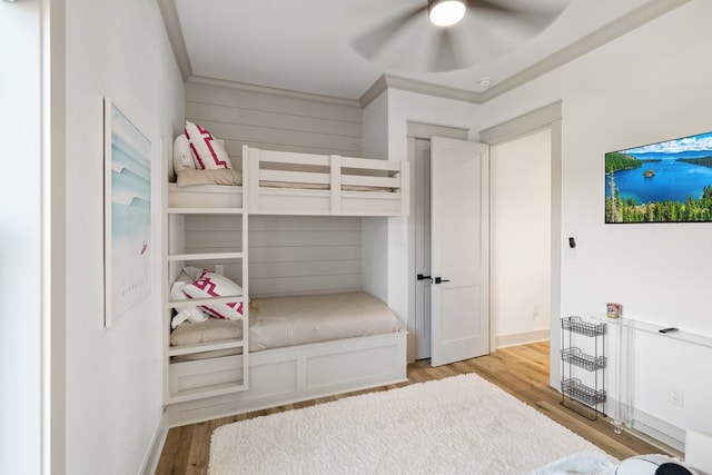 bedroom with ceiling fan, light hardwood / wood-style flooring, and ornamental molding