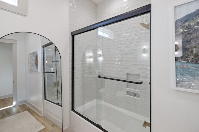 bathroom featuring shower / bath combination with glass door and hardwood / wood-style flooring