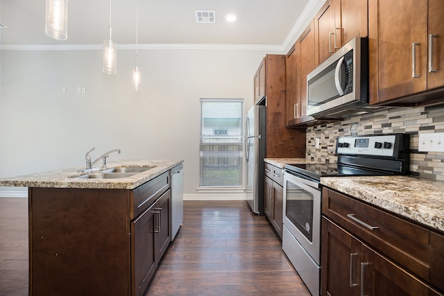 kitchen featuring crown molding, appliances with stainless steel finishes, pendant lighting, sink, and dark wood-type flooring