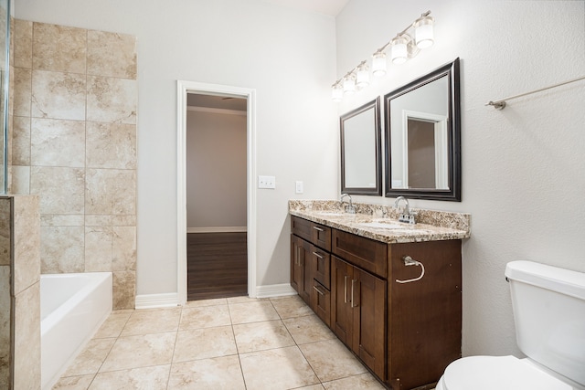 bathroom featuring toilet, a tub to relax in, vanity, and tile patterned flooring