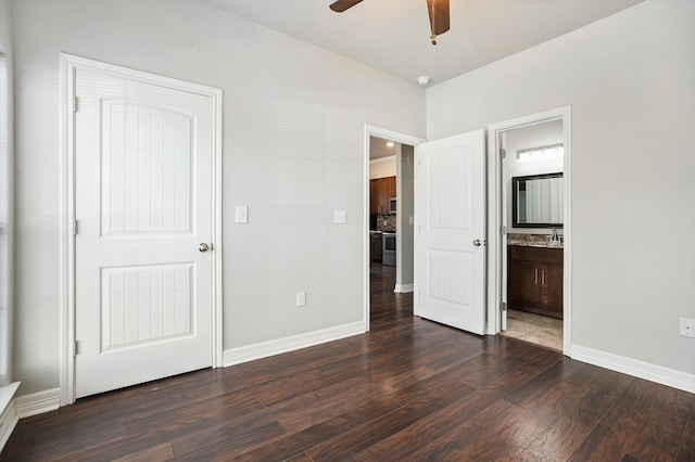 unfurnished bedroom with dark wood-type flooring, ceiling fan, and ensuite bath