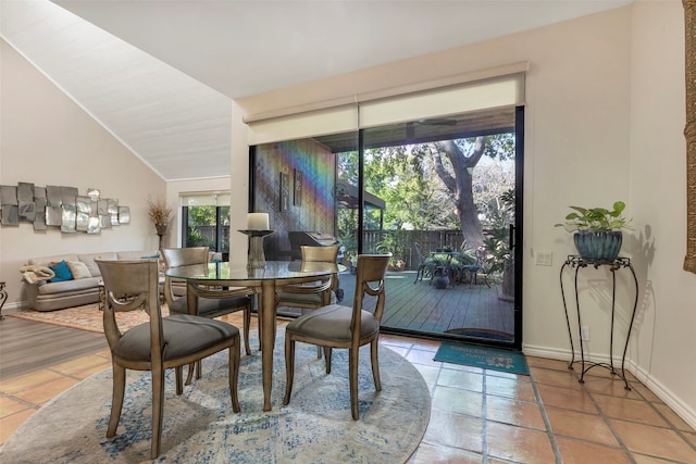 dining area featuring lofted ceiling