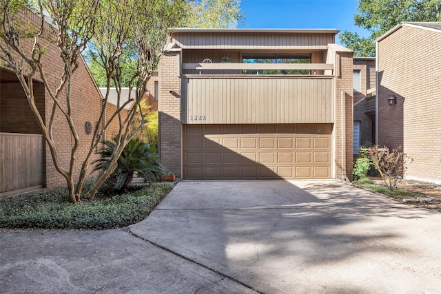 view of front of home with a balcony and a garage