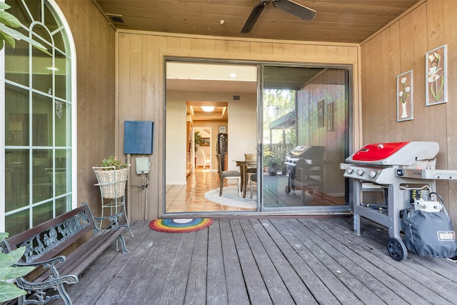 wooden deck featuring grilling area and ceiling fan