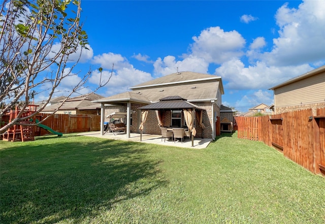 back of house with a lawn, a playground, a gazebo, and a patio area