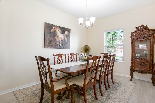 dining space with an inviting chandelier and light wood-type flooring