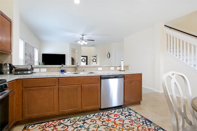 kitchen with appliances with stainless steel finishes, sink, light tile patterned floors, and ceiling fan