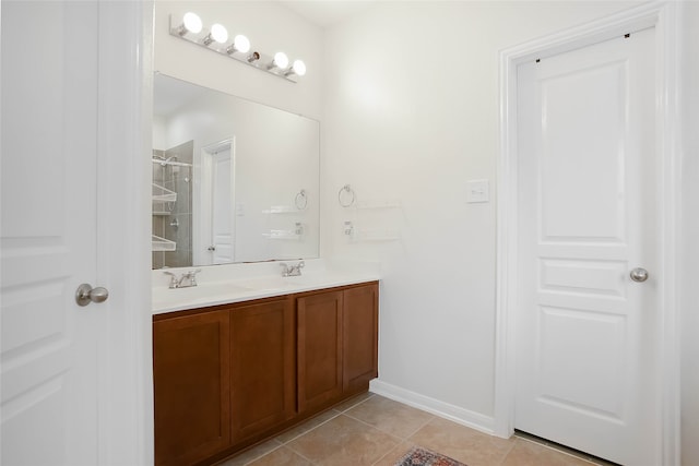 bathroom with tile patterned flooring, vanity, and a shower with door