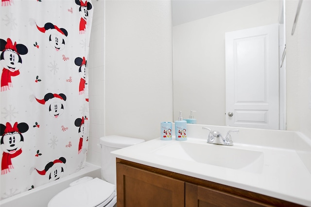 full bathroom with vanity, shower / bath combo with shower curtain, and toilet