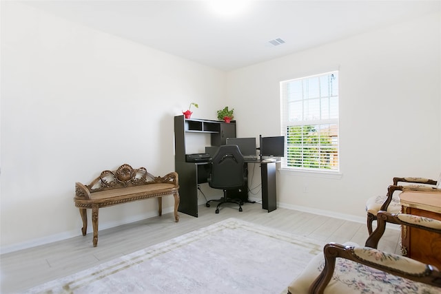 office space with light hardwood / wood-style flooring