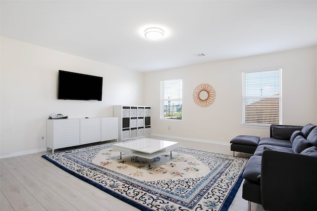 living room with a wealth of natural light and light hardwood / wood-style floors