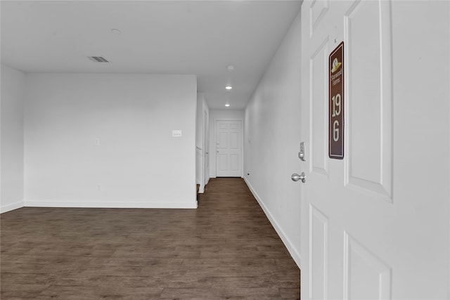 corridor with dark wood-type flooring