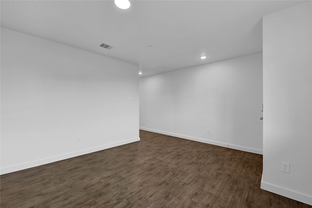 spare room featuring dark hardwood / wood-style floors