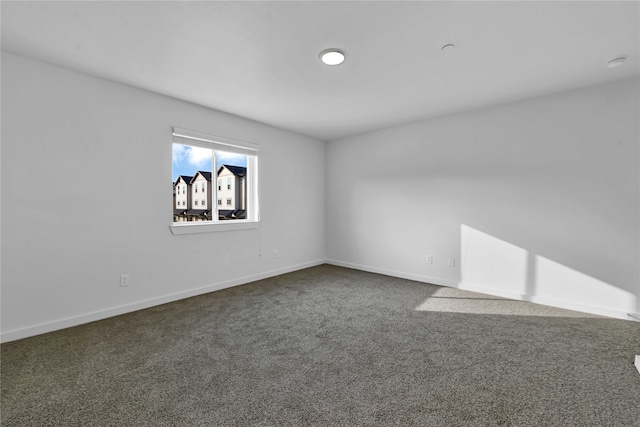 empty room featuring dark colored carpet