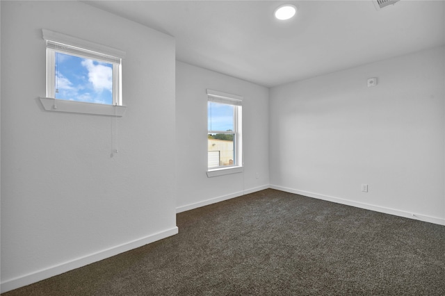 carpeted empty room featuring a healthy amount of sunlight