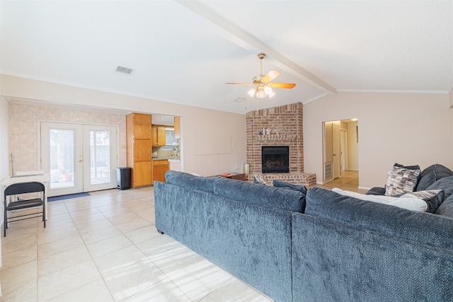 living room with french doors, vaulted ceiling with beams, tile patterned flooring, ceiling fan, and a fireplace