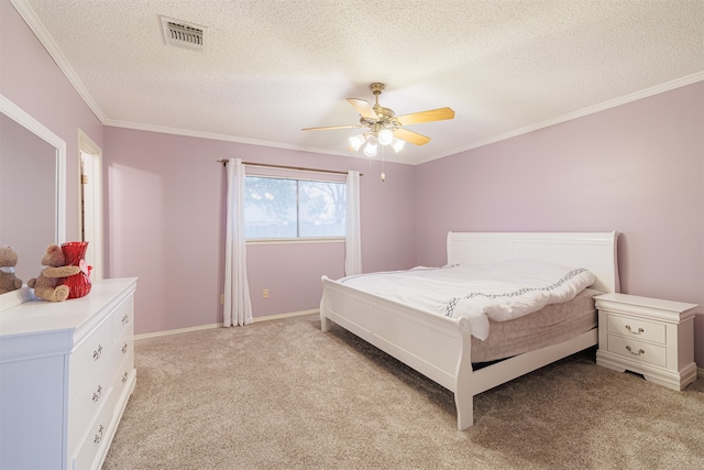 carpeted bedroom with ornamental molding, a textured ceiling, and ceiling fan