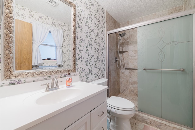 bathroom with walk in shower, vanity, a textured ceiling, and toilet