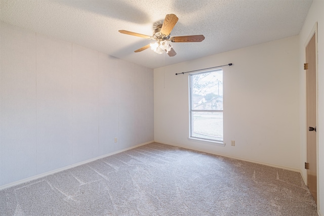 empty room featuring ceiling fan, a textured ceiling, and carpet