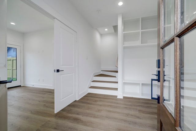 staircase with hardwood / wood-style floors