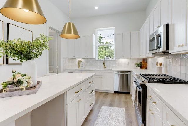 kitchen featuring white cabinetry, stainless steel appliances, sink, and tasteful backsplash