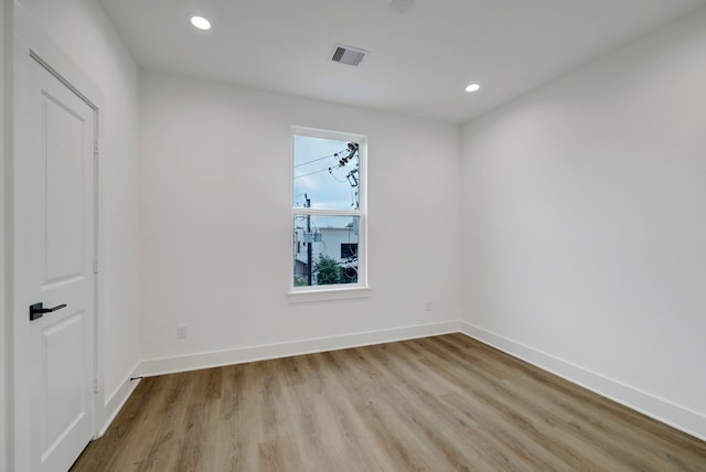 spare room with light hardwood / wood-style flooring