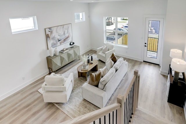 living room with a wealth of natural light and light hardwood / wood-style flooring