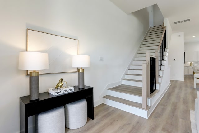 staircase with wood-type flooring