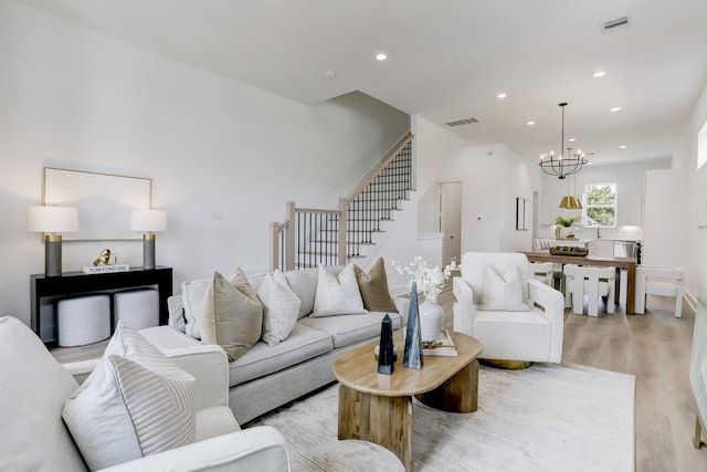 living room featuring light hardwood / wood-style flooring and a chandelier