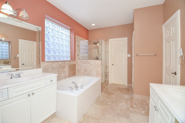 bathroom featuring shower with separate bathtub and vanity