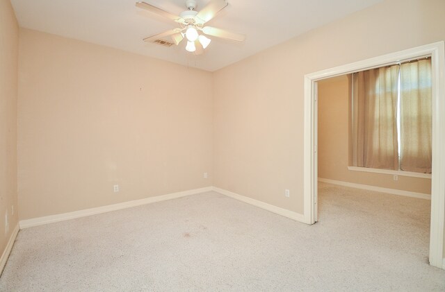 unfurnished room featuring ceiling fan and light carpet